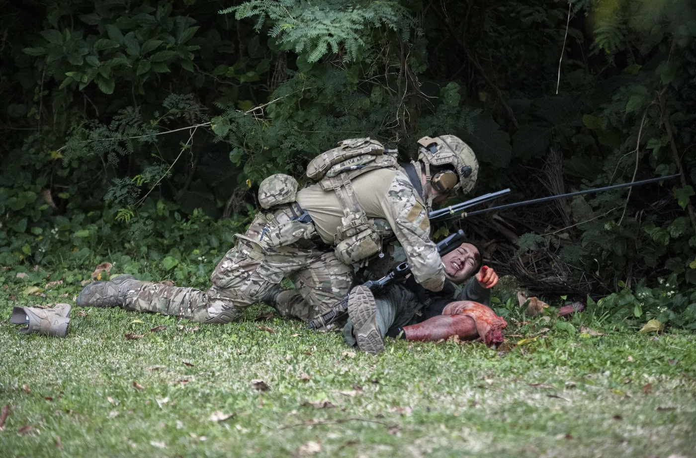 Operator treating a simulated casualty in cover