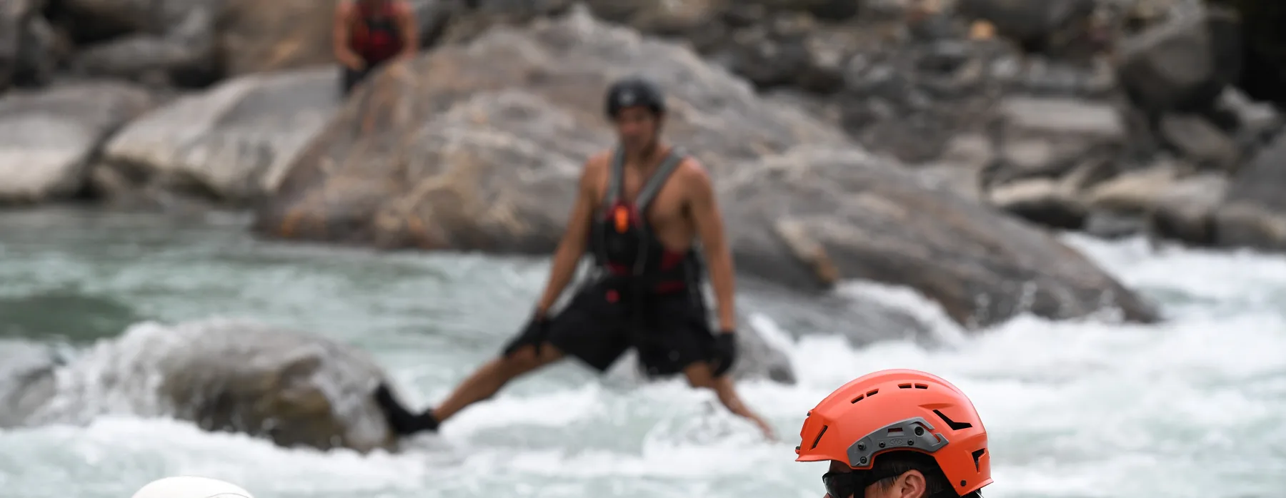 Rescue swimmer working through a river rapid
